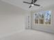 Bright bedroom with large window, ceiling fan, and neutral carpeting at 2105 Gentry Rd, Wake Forest, NC 27587