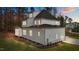 Rear view of a two-story white home with a screened porch and yard at 2105 Gentry Rd, Wake Forest, NC 27587