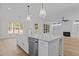 Open concept kitchen with large island and views into the living room at 2105 Gentry Rd, Wake Forest, NC 27587