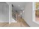 View of hardwood floors, staircase, and large window from entryway at 2105 Gentry Rd, Wake Forest, NC 27587