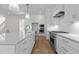 White kitchen with stainless steel appliances and hardwood floors at 2105 Gentry Rd, Wake Forest, NC 27587