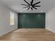 Spacious bedroom with dark green accent wall and hardwood floors at 2105 Gentry Rd, Wake Forest, NC 27587