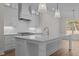 Modern kitchen island with white cabinets and quartz countertops at 2105 Gentry Rd, Wake Forest, NC 27587