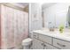 Bathroom with a pink shower curtain and vanity at 204 Harvest Ln, Pittsboro, NC 27312