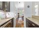 Butler's pantry with granite countertop and wine cooler, connecting to dining room at 204 Harvest Ln, Pittsboro, NC 27312