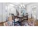 Open dining room with hardwood floors, chandelier, and views to the Gathering room at 204 Harvest Ln, Pittsboro, NC 27312