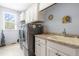 Laundry room with washer, dryer, sink, and ample cabinetry at 204 Harvest Ln, Pittsboro, NC 27312