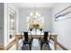 Bright dining room with glass-top table, four chairs, and view of the backyard pool at 204 Harvest Ln, Pittsboro, NC 27312