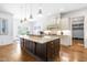 Gourmet kitchen with granite island, custom cabinetry, and stainless steel appliances at 204 Harvest Ln, Pittsboro, NC 27312