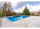 Inviting swimming pool with stone patio and water feature at 204 Harvest Ln, Pittsboro, NC 27312