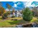 Gray house with a screened porch, pool, and pond in the background at 204 Harvest Ln, Pittsboro, NC 27312