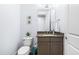Powder room with granite countertop, dark brown vanity, and toilet at 204 Harvest Ln, Pittsboro, NC 27312