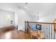 Upper hallway with hardwood floors and decorative accents at 204 Harvest Ln, Pittsboro, NC 27312