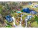 Aerial view of homes and pond in a quiet neighborhood at 204 Harvest Ln, Pittsboro, NC 27312