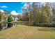 Serene backyard with pond and trees at 204 Harvest Ln, Pittsboro, NC 27312