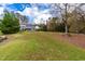Spacious backyard with lush lawn and mature trees at 204 Harvest Ln, Pittsboro, NC 27312