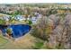 Aerial view of homes, pond and surrounding forest at 204 Harvest Ln, Pittsboro, NC 27312