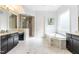 Main bathroom with soaking tub, walk-in shower, and dual vanities at 204 Harvest Ln, Pittsboro, NC 27312