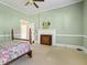 Spacious bedroom with fireplace and floral bedding at 715 E Broad St, Fuquay Varina, NC 27526
