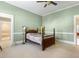 Bedroom with wooden bed frame and view of bathroom at 715 E Broad St, Fuquay Varina, NC 27526