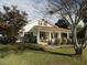 Charming yellow house with a large front porch and mature trees at 715 E Broad St, Fuquay Varina, NC 27526