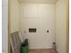 Small laundry room with tile flooring and wood paneling at 715 E Broad St, Fuquay Varina, NC 27526