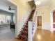 Elegant staircase with patterned carpeting and wood railings at 715 E Broad St, Fuquay Varina, NC 27526