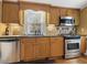 Kitchen with stainless steel appliances and wood cabinets at 715 E Broad St, Fuquay Varina, NC 27526