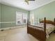 Spacious bedroom with ceiling fan and hardwood floors at 715 E Broad St, Fuquay Varina, NC 27526