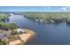 Aerial view of lakefront community with sandy beach at 110 Wounded Knee Dr, Louisburg, NC 27549