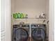 Convenient laundry room with washer, dryer, and shelving at 143 Rawhide Dr, Louisburg, NC 27549