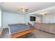 Entertaining game room, including a ping pong table and large TV at 143 Rawhide Dr, Louisburg, NC 27549