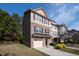 Three-story townhome with a brick and shingle exterior and a two-car garage at 254 Linden Park Ln Ln, Cary, NC 27519