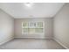 Bright bedroom featuring a window with blinds and grey carpet at 254 Linden Park Ln Ln, Cary, NC 27519