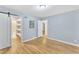 Spacious bedroom with hardwood floors, open shelving, and ensuite access at 2600 Wade Ave, Raleigh, NC 27607