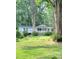 White ranch home with a covered porch, set back from the road and surrounded by trees at 325 Ranch Farm Rd # A - B, Raleigh, NC 27603