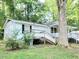 White house with front porch, steps, and large tree at 325 Ranch Farm Rd # A - B, Raleigh, NC 27603