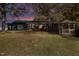 Ranch home with a large yard, gazebo, and mature trees at dusk at 2524 Christian Light Rd, Fuquay Varina, NC 27526