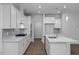 Modern kitchen with white cabinets, quartz countertops, and stainless steel appliances at 115 Fairwinds Dr, Lillington, NC 27546