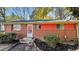 Brick ranch house with red accents, steps, and landscaping at 720 Darby St, Raleigh, NC 27610
