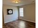 Spacious bedroom with laminate flooring and large window at 747 Brewers Glynn Ct, Wake Forest, NC 27587