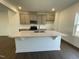 Kitchen island with white quartz countertop, perfect for meal prep at 809 Basswood Gln Trl, Knightdale, NC 27545