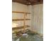 Unfinished interior room with wooden shelves and pegboard at 6349 Elevation Rd, Benson, NC 27504