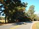 Curved road with tall trees and field at 6349 Elevation Rd, Benson, NC 27504