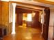 Formal dining room with hardwood floors and brick accent wall at 6349 Elevation Rd, Benson, NC 27504