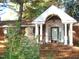 Brick ranch home with a classic portico and landscaped yard at 6349 Elevation Rd, Benson, NC 27504