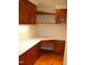 Corner desk with wood cabinets and hardwood floor at 6349 Elevation Rd, Benson, NC 27504