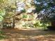 Landscaped yard with trees and a brick structure at 6349 Elevation Rd, Benson, NC 27504