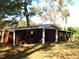Red outbuilding with covered porch and white columns at 6349 Elevation Rd, Benson, NC 27504