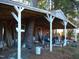 Rustic covered porch with a tree growing through the supports at 6349 Elevation Rd, Benson, NC 27504